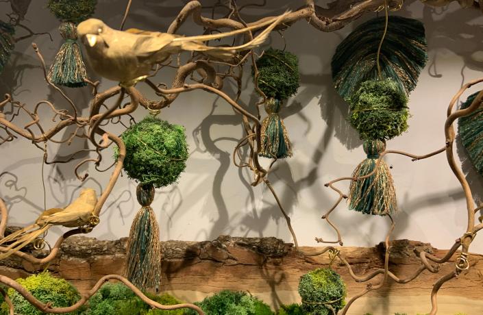 Décoration de la conciergerie avec morceaux de bois imitant des branches et un oiseau