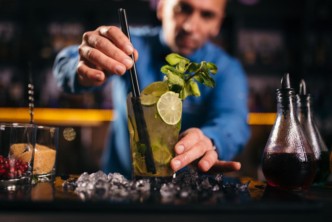 Barman qui prépare un cocktail derrière le Grrizzly Bar à Courchevel